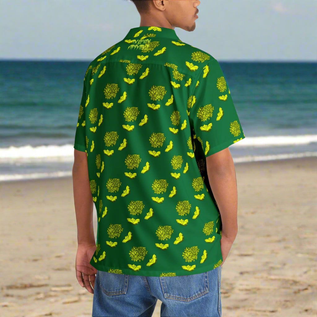 Man wearing a green shirt with yellow pattern on a beach background