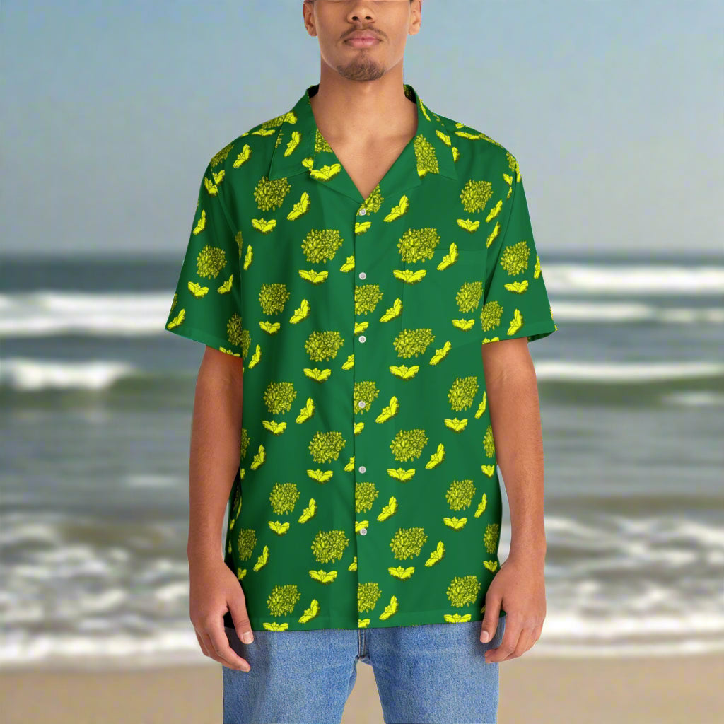 Man wearing a green shirt with yellow pattern on a beach background