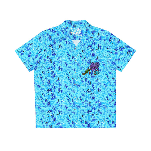 Lilac pattern on a Hawaiian shirt, the color is light blue with dark highlights and on the front left pockets there is a drawing of a lilac flower and a butterfly 