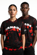 Two people wearing black and red 'Canada' jerseys on a white background