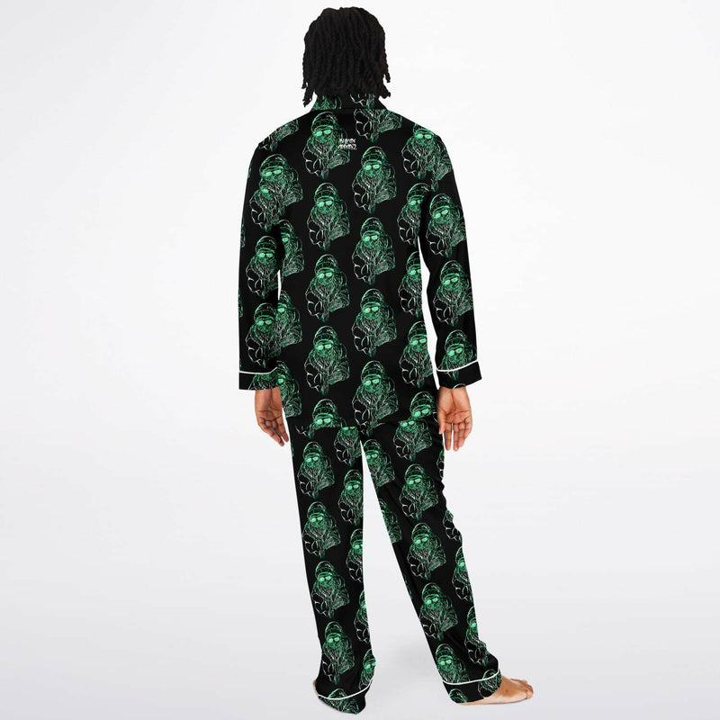 Person wearing a black pajama set with green alien pattern on a white background