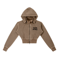 A cropped zip-up hoodie in a washed taupe-brown color, featuring a black graphic text print on the left chest that reads 'DUKIRI APPAREL'. The hoodie has a full front zipper, a hood, and ribbed cuffs and hem, shown against a plain white background.