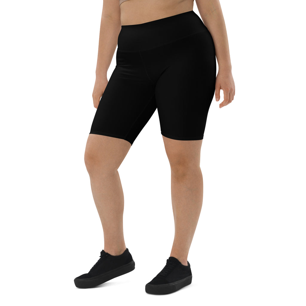 Person wearing black athletic shorts with a colorful waistband on a white background