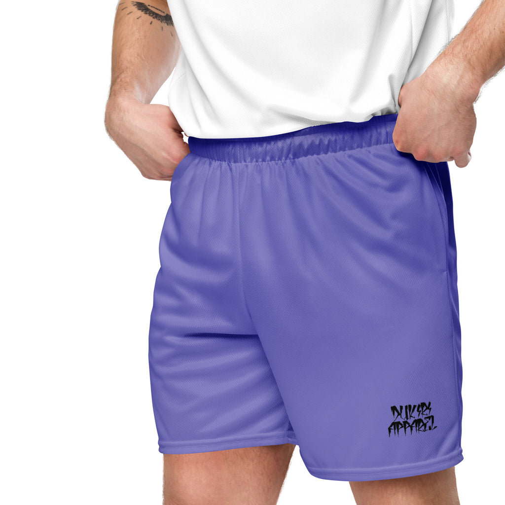 Fit white male model wearing purple mesh athletic shorts during outdoor workout, demonstrating flexibility and comfort.