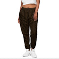 Woman wearing a white crop top and patterned pants on a white background