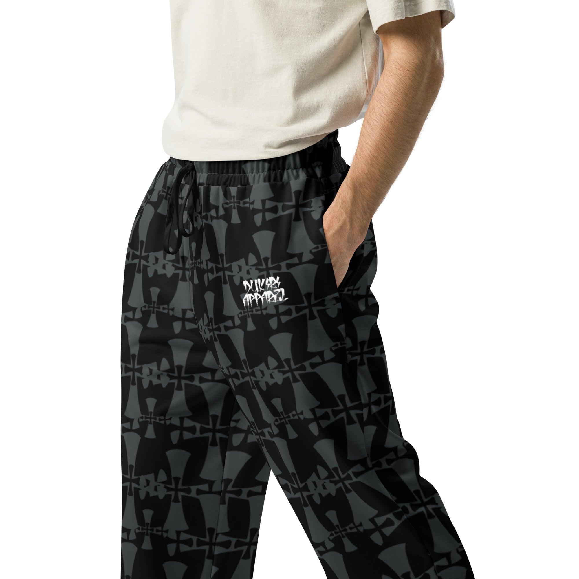 crusaders wide leg premium joggers in grey and back. Cross patterns all over print worn by man.