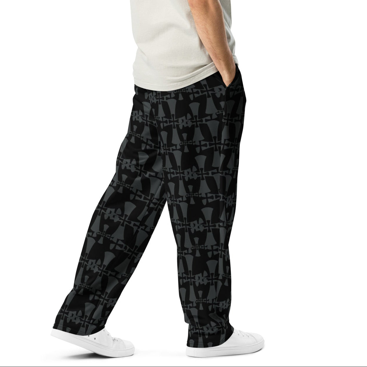 crusaders wide leg premium joggers in grey and back. Cross patterns all over print worn by man.
