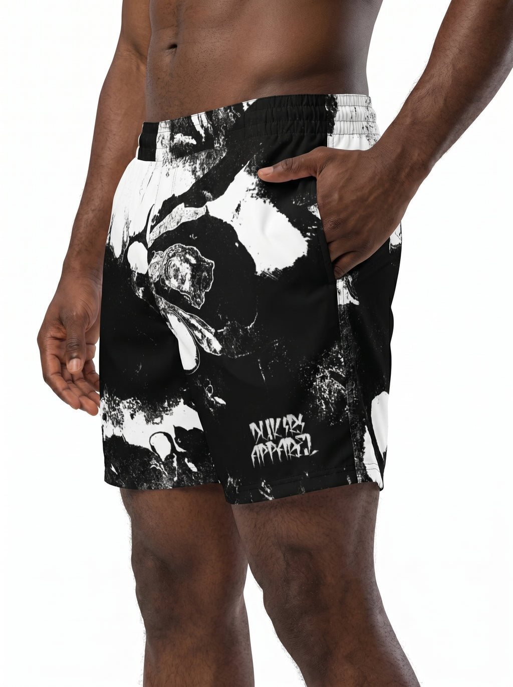 Black swim shorts with white graphic design worn by a person on a white background