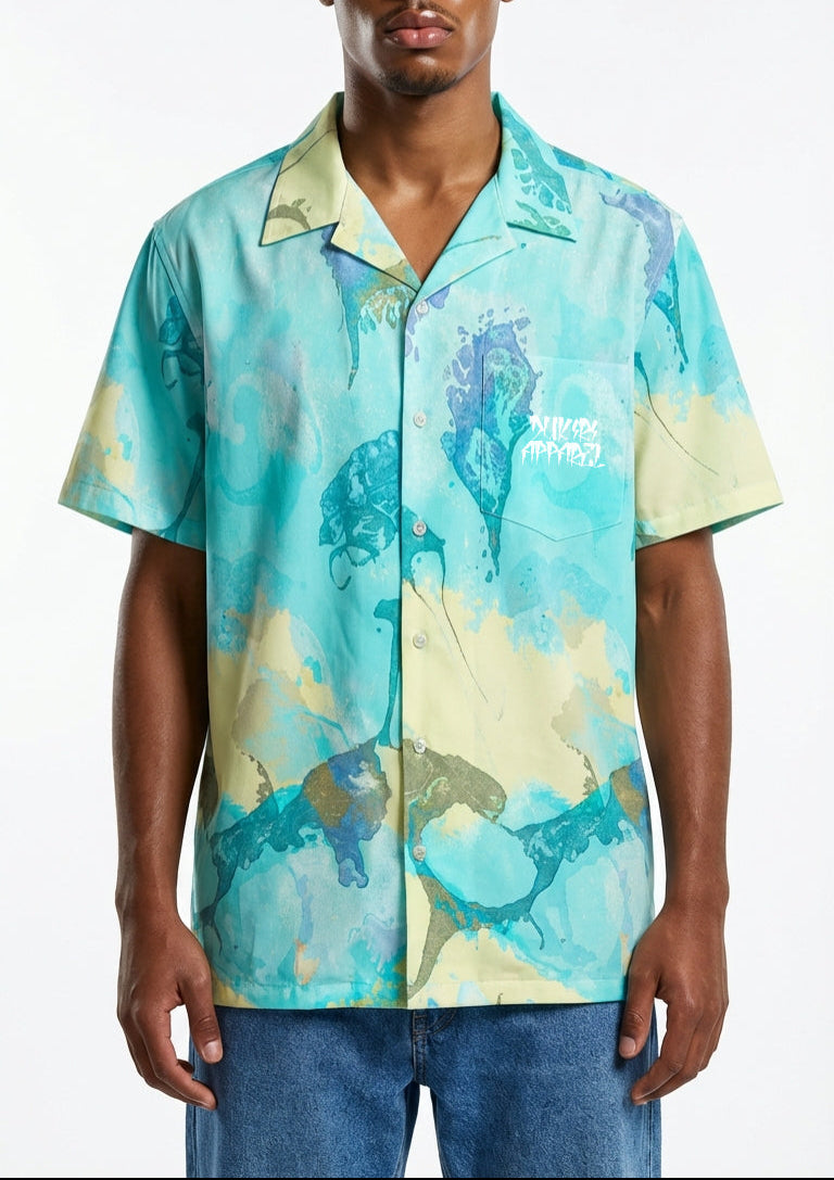 Man wearing a colorful short-sleeve shirt with abstract design on a white background