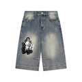 Light blue denim shorts with a black and white graphic print of a woman surrounded by flowers on the left leg, shown flat on a white background.