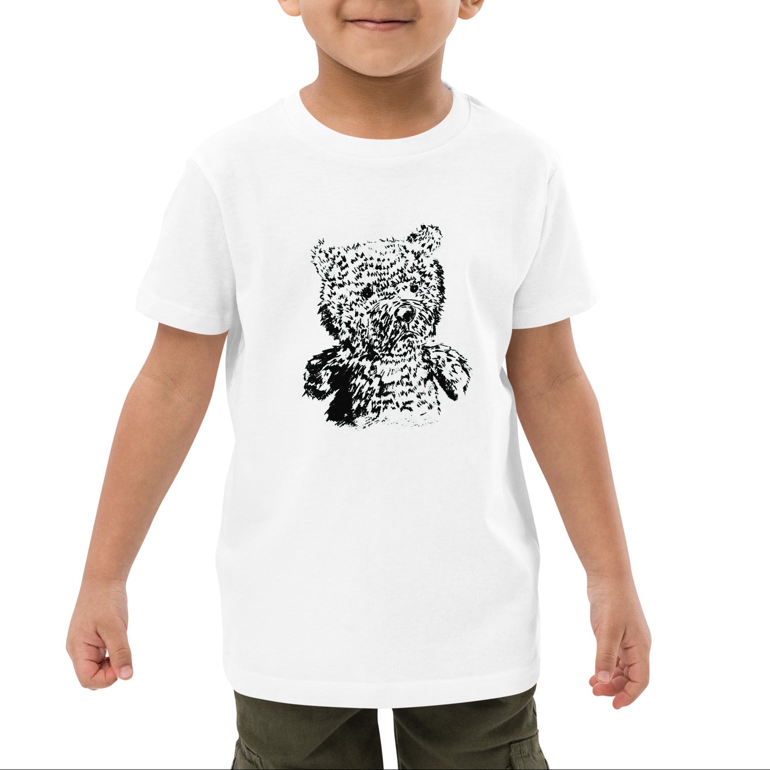A young boy wearing a white short-sleeve t-shirt with a black pixelated teddy bear graphic on the front, set against a plain white background.