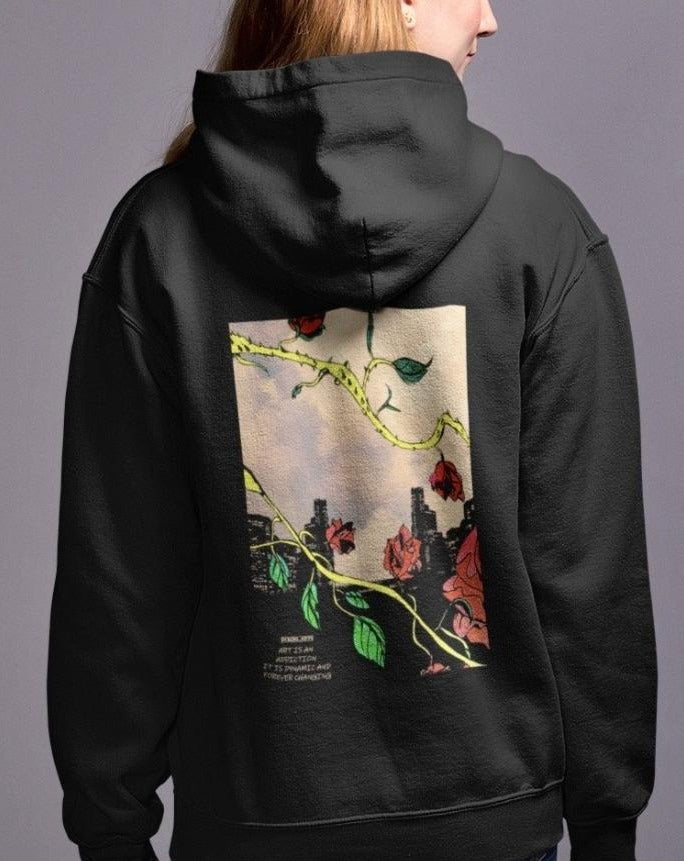 a woman wearing a black hoodie with a picture of flowers on it